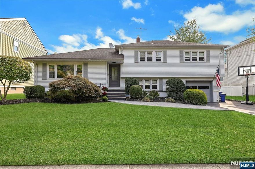 Welcome to this beautifully updated traditional split-level home, ideally located in the heart of River Edge. Offering 4 spacious bedrooms, including a private primary suite with its own bathroom, this home blends comfort with modern convenience. The interior showcases a brand-new kitchen, new bathrooms, refinished hardwood floors, and freshly painted rooms throughout. A new HVAC system ensures year-round comfort. The lower-level family room provides ground-level access to the backyard, where a paver patio and level lawn create the perfect setting for outdoor living and entertaining. Exterior upgrades include new front steps with paver walkway, new entry door, refinished driveway with Belgian block border, and an in-ground sprinkler system. An attached garage adds convenience and daily ease. Set on a quiet non-through street across from a picturesque stream and protected town property, the location offers unique privacy and natural beauty. River Edge is prized for its top-rated schools, two modes of NYC transportation, and central location near shopping, dining, and major highways.