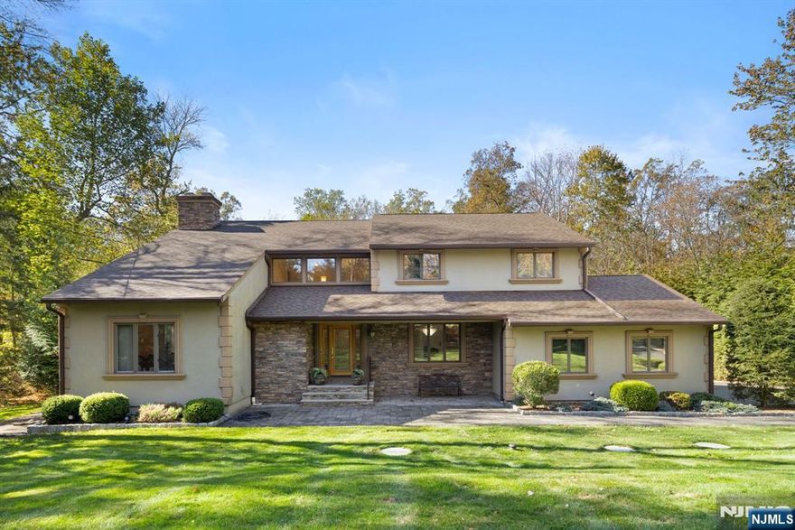 Welcome to this stunning, updated Center Hall Colonial immaculately kept nestled on nearly 2 private acres! Step through the elegant leaded glass front door into a sun-drenched two-story foyer, highlighted by a custom open wood staircase with wrought iron spindles. The first floor features gleaming hardwood floors, a sunken family room with dual gas fireplace and a beautiful Salerno kitchen with French doors opening to a spacious deck overlooking the lush & mature landscaped backyard and in-ground saltwater pool with new liner, pavers & added outdoor shower. Off the kitchen, you'll find a convenient mudroom/laundry room with yard access. Upstairs, the primary suite offers a sitting room or office loft, a luxurious bath, and a dressing area. Three additional generous bedrooms with ample closets and a full main bath complete the level. The finished basement includes a gym, game room, abundant storage, and utilities - plus a generator and RO Filtration System for peace of mind. Move-In Ready in Impeccable Condition - Don't miss the opportunity!