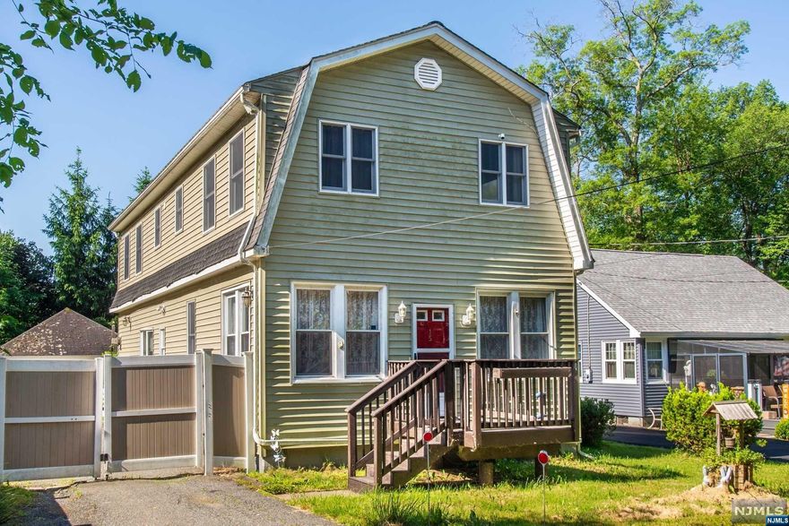 Expansive 4-bedroom, 3-bath colonial on a corner lot just steps away from beautiful Greenwood lake! The first floor offers an updated EIK Stailess steel appliances with two pantries, a spacious and bright living room, mudroom, full updated bath, and a den with French doors leading to the back deck. The second floor features an office nook, laundry room, three generous bedrooms, an updated guest bath, and a master suite with a huge walk-in closet and updated master bathroom. The half-acre property is level, equipped with two sheds, an oversized heated garage, and a lengthy driveway accommodating 8-10 cars. Enjoy the convenience of natural gas with no oil. This is an incredible opportunity " no flood risk!