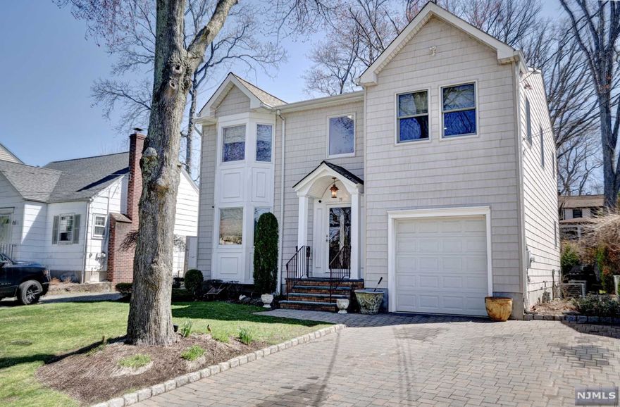 Picture perfect 3 Bedroom, 2.5 Bathroom home built in 2008 on a quiet tree-lined street walking distance to NYC bus stop, town center, restaurants and shopping! Quality craftsmanship describe this Colonial home with hardwood floors throughout, crown molding, designer finishes, professionally landscaped front and rear yard and paver driveway and walk-way. Enter into the foyer leading to the spacious Living Room, Formal Dining Room and Kitchen with rich natural wood cabinetry, granite countertops, large center island with seating, Powder Room and entrance to the flat backyard with paver patio. Perfect for entertaining! The 2nd floor is home to all 3 over-sized Bedroom and 2 Full Baths. The Master suite is complete with large closet, spa-like Master Bath with stall shower with frameless shower doors and jetted tub. The Full Basement is ready to be finished for extra living space. The garage has built-in storage shelving.