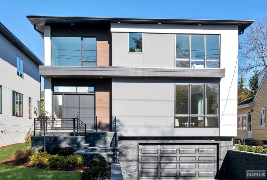 Come see this BRAND NEW MODERN MASTERPIECE designed by renowned architect Jordan Rosenberg and built by Strategic Properties. This extraordinary 5,500 SF home is located only 1 mile from the George Washington Bridge and has all the latest design features including an open floor plan, 10' 1st floor ceiling height, customized kitchen cabinetry designed and imported from England, commercial grade appliance package, floor to ceiling windows, cable railing system and linear gas fireplace. The master bedroom suite includes an entry foyer, his/her closets, bathroom with radiant heat, signature wall of imported statuario porcelain tile and frosted glass doors to shower and toilet rooms. Lower level features recreation room, bedroom, full bath, mud room built-Ins and a large walk-in closet. Other features include an oversized maintenance free deck, energy efficient heating and Insulation package and room for a pool. Owner has NJ Real Estate License.