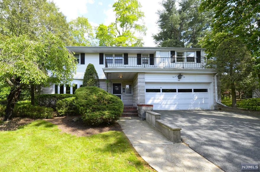"Beautiful split level home located on quiet Magnolia Ave in one of Tenafly's historic districts. This home features 3 bedrooms, 2 full bathrooms, 1 half bath, and a 2 car garage. The ground level welcomes you with a bright family room, 1/2 bathroom, and a coat closet. The home's first level features a large living room with fireplace, a dining room with access to the patio, and kitchen with backyard access. On the second level, there is a primary suite with primary bathroom plus 2 additional bedrooms and a full bath. Completing this home, there is a finished basement equipped with a bar, laundry room and multiple closets. Located walking distance to the center of town and bus transportation to NYC, walking distance to Maugham School (elementary), close to middle and high school and houses of worship, minutes drive to Route 9W with easy access to GWB."