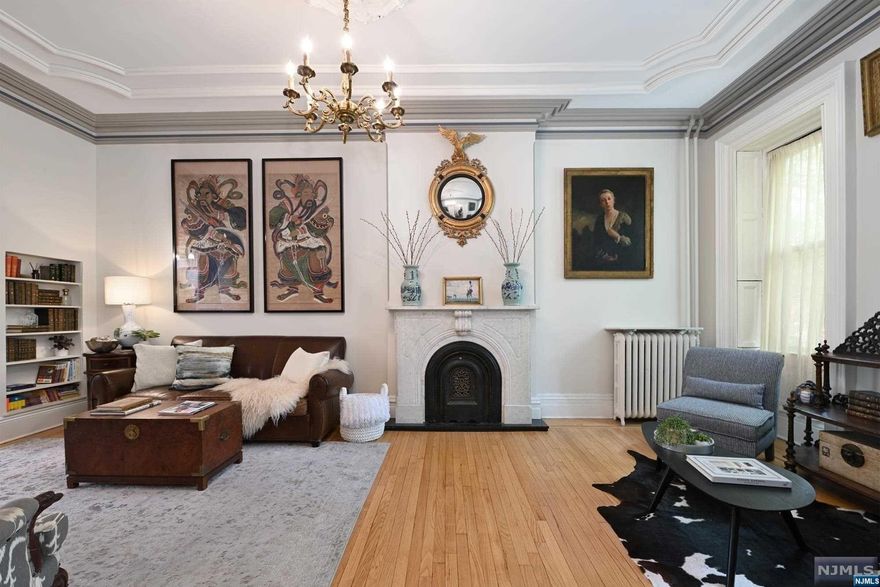 A unique and rare opportunity awaits in historic Van Vorst Park. 301 Varick Street is a classic grand brownstone constructed in 1869, boasting beautiful original details throughout! This multi-family home comprises 4 floors of living space, 5 bedrooms, and 3.5 baths. History and elegance are sensed as you step inside the parlor level with its exceptionally high ceilings, finding a spacious open living room with original mantle and moldings. The dining room and kitchen, designed by C+C Architects, feature white cabinetry, quartzite backsplash and countertops, and an island perfect for family meetings, homework headquarters, and where all your friends will want to gather, with a powder room close by. Off the kitchen are 2 doors leading out onto the deck covered with a retractable awning, warmed with heat lamps, and a grill with a dedicated gas line. A spiral staircase leads to the lovely landscaped garden. The third floor offers the primary bedroom with a walk-in closet.