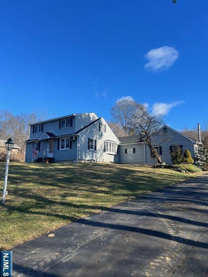 Welcome to Stonetown! Tucked back from the road and set on over 1.7 acres, this charming expanded Cape Cod offers the perfect blend of privacy and comfort. Inside, you'll find a well-appointed eat-in kitchen, a cozy office nook, and a stunning great room featuring cathedral ceilings, skylights, and a wood-burning stove perfect for gathering year-round. The main level also hosts a spacious primary bedroom complete with a large walk-in closet, while two additional bedrooms are located upstairs. With a full bathroom on each level, the layout offers both convenience and flexibility. Freshly updated with new hardwood flooring on the first floor, new wall-to-wall carpeting on the second floor and staircase, and recently painted throughout, this home is truly move-in ready. A detached garage adds even more versatility, ideal for a workshop, storage, or your next creative space.