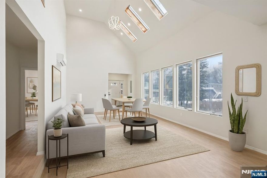 Welcome home to this newly constructed 3-bedroom, 3-bathroom Colonial nestled on a wooded lot in the heart of Wayne, where modern design meets everyday comfort. Step into the inviting entry foyer that opens to a bright, open main living space. The sunlit living and dining room combination features soaring ceilings, skylights, and expansive windows, creating an ideal setting for daily living and entertaining. The dining area flows seamlessly into the beautifully designed kitchen with custom cabinetry, a center island, and brand-new appliances perfect for gathering and making memories. Down the hall, the first floor primary bedroom offers a peaceful retreat complete with walk in closet, full bathroom and access to the private balcony. A second bedroom and full bathroom complete the main level. Retreat upstairs to discover a spacious family room, ideal for relaxing, hosting movie nights or entertaining. Sliding glass doors lead out to the balcony. A generously sized bedroom, full bathroom, and laundry room complete the level. The fully finished walk-out ground level provides exceptional bonus space, perfect for a den, home office, gym, or hobby room. Sliding glass doors from the kitchen lead to a rear deck, ideal for outdoor entertaining, grilling, or al fresco dining surrounded by nature. A 1-car attached garage completes this thoughtfully designed new construction home, offering space, style, and comfort indoors and out.