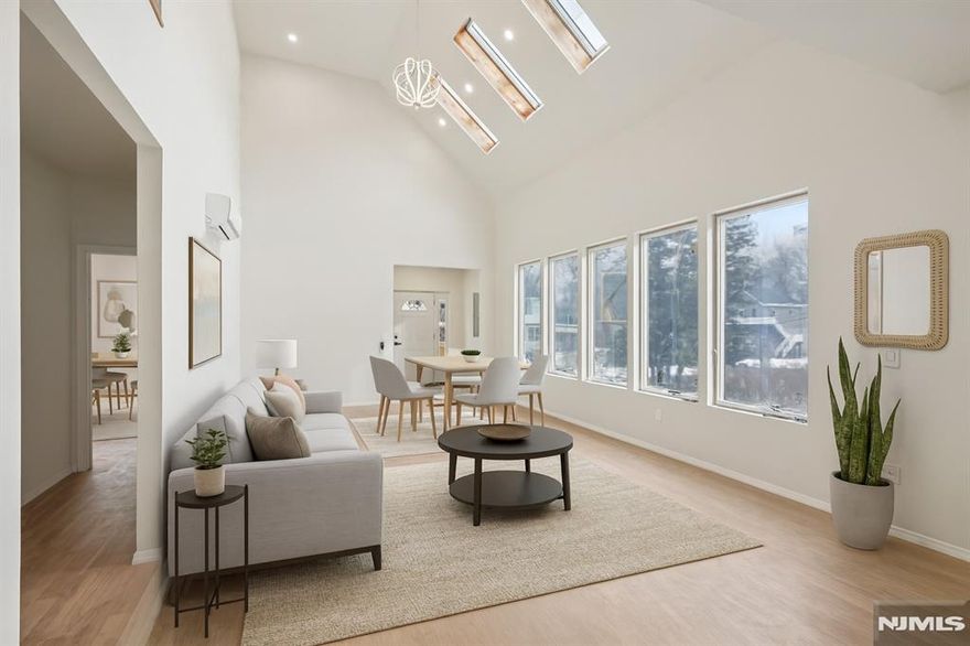 Welcome home to this newly constructed 3-bedroom, 3-bathroom Colonial nestled on a wooded lot in the heart of Wayne, where modern design meets everyday comfort. Step into the inviting entry foyer that opens to a bright, open main living space. The sunlit living and dining room combination features soaring ceilings, skylights, and expansive windows, creating an ideal setting for daily living and entertaining. The dining area flows seamlessly into the beautifully designed kitchen with custom cabinetry, a center island, and brand-new appliances perfect for gathering and making memories. Down the hall, the first floor primary bedroom offers a peaceful retreat complete with walk in closet, full bathroom and access to the private balcony. A second bedroom and full bathroom complete the main level. Retreat upstairs to discover a spacious family room, ideal for relaxing, hosting movie nights or entertaining. Sliding glass doors lead out to the balcony. A generously sized bedroom, full bathroom, and laundry room complete the level. The fully finished walk-out ground level provides exceptional bonus space, perfect for a den, home office, gym, or hobby room. Sliding glass doors from the kitchen lead to a rear deck, ideal for outdoor entertaining, grilling, or al fresco dining surrounded by nature. A 1-car attached garage completes this thoughtfully designed new construction home, offering space, style, and comfort indoors and out.