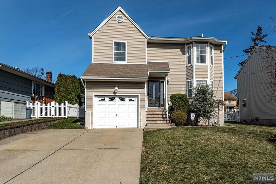 Welcome to this beautiful 3 bedroom, 2.5 bath home in the heart of Elmwood Park. As you enter the front door, you'll feel right at home with a nice size living room, open concept kitchen to dining room, half bath, and beautiful sliding doors for yard access. The second floor has your master bedroom and bathroom with two walk in closets, jacuzzi tub and shower stall. On the second floor, you will also find two additional nice size bedrooms with another full bathroom and large closet. The basement is finished with a large family room, laundry room, ample storage, utilities and access to the backyard. This home has beautiful curb appeal, large driveway, an attached 1 car garage with direct access and opener, a security system, and 4 zone sprinkler system. This house is perfect for entertaining with a beautiful yard, gas BBQ, and patio. Close to transportation, schools, shopping, and place of worship!