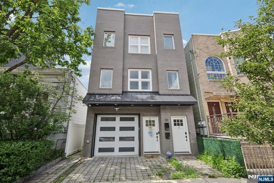 Beautifully designed 1,800 sq ft duplex unit built in 2021, spanning the entire first and second floors of a modern two-family home in desirable Jersey City Heights. The first floor features a spacious, versatile open area perfect as a playroom, home office, guest room, or creative space, complete with a convenient half bathroom and direct access to a private backyardâ€”ideal for relaxing or entertaining. Upstairs, enjoy a bright, open-concept kitchen, living, and dining area with quartz countertops, stainless steel appliances, custom cabinetry, hardwood floors, and soaring ceilings. Three generously sized bedrooms and two full bathrooms complete the upper level, including a serene primary suite with en-suite bath and ample closet space. Additional highlights include in-unit washer/dryer, central heating and cooling, and one tandem garage parking spot. The building is shared with only one other unit, providing privacy and a quiet environment. Located near parks, schools, shopping, dining, and NYC transit options. Tenant pays gas and electricity.