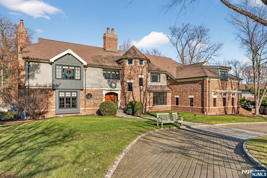 Experience resort-style living in this exceptional North Caldwell residence, where timeless craftsmanship meets modern luxury. A grand marble entry with a sweeping staircase sets the tone, complemented by soaring ceilings, deep moldings, gleaming hardwood floors, and a richly appointed mahogany library. Built with steel beam construction and surrounded by lush landscaping, water features, and mature gardens, this home radiates quality inside and out. The handcrafted Canterbury-design gourmet kitchen is a true showpiece with premium materials and thoughtful detailing, opening to a bright, year-round solarium. Upstairs, the impressive primary suite includes a spa-like bath with an oversized shower and soaking tub, while all additional bedrooms are ensuite and generously sized. The finished lower level is an entertainer's dream featuring mahogany millwork, a wine cellar, professional bar, FULL SWING GOLF PRO simulator, projection screen, exercise room, and abundant storage. Step outside to your private oasis with a custom in-ground pool with hot tub, tranquil koi pond, multiple patios, an outdoor BBQ kitchen, and beautifully landscaped grounds. Offering unmatched luxury and lifestyle, this home delivers Montclair-style living with low North Caldwell taxes just 17 miles to NYC and minutes to trains, dining, parks, and a short distance to top public school system. A rare opportunity not to be missed.