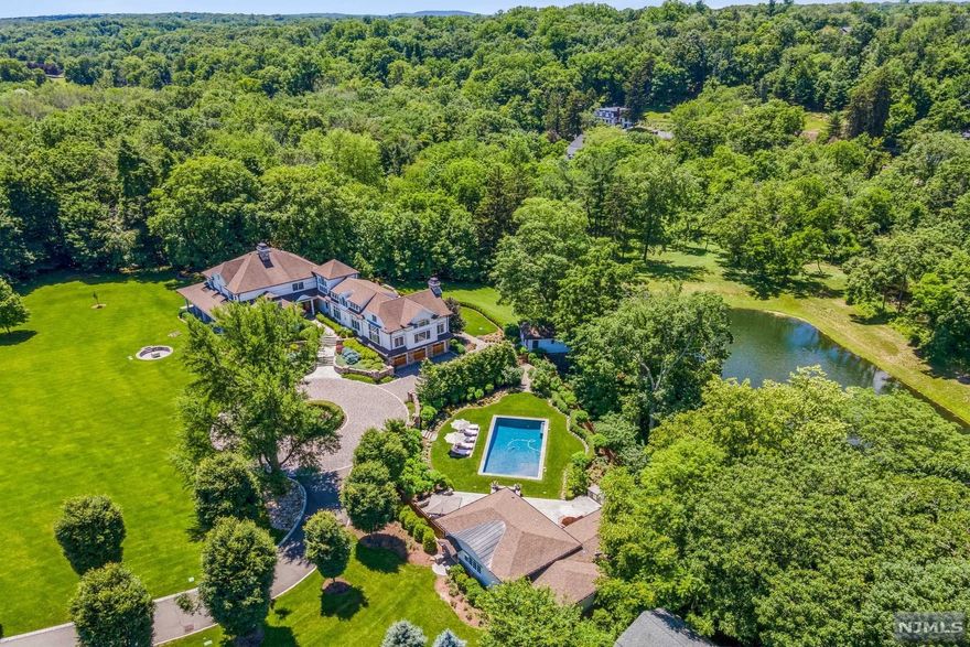 One of the most pristine, gut renovated, restored and expanded colonial farmhouse compounds is now available to the buyer who wants the quintessential "lifestyle estate". Soaring ceilings, and walls of glass overlook approximately 10 sprawling, rolling acres of land. A long Belgium block-lined courtyard driveway leads you to a fieldstone and cedar colonial home wrapped by a porch. Large and dramatic, yet not cavernous, each bedroom is a suite, with the Main suite on the 1St level. Cathedral ceilings in both the Chefs Kitchen and Great Room overlook the East and West great lawns. Reception rooms include a Study, Formal Living Room, Formal Dining Room, Morning Room, and Gallery. On the Grounds, a restored Antique Ice House features a Gymnasium overlooking a pond. Beautiful Gunite Pool with separate large hot tub features a Guest House with Family Room and Bath. LOW TAXES!! NOTHING QUITE LIKE THIS ANYWHERE!