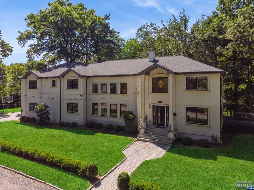 Welcome to this stunning modern home located on the desirable East Hill of Demarest. This luxurious property offers an abundance of natural light & contemporary elegance throughout. As you enter, you'll be greeted by large windows that flood the home w/sunlight. The open floor plan seamlessly flows into the Sub Zero/Viking gourmet kitchen w/ direct access to a spacious deck and new stone lower patio. Perfect for entertaining. The family room boasts a soaring high ceiling, cozy fireplace, custom bar w/ glass wine rm creating the ideal space for relaxation & gatherings. The private primary suite is a true retreat, featuring a sitting area, fireplace, custom walk-in closet, & spa-like bathroom, soaking tub & separate shower. A junior en-suite bedroom & two additional bedrooms connected by a jack & jill bathroom provide ample space for family & guests. Convenience is key, w/ a second-floor laundry room & Nest smart technology integrated throughout the home.