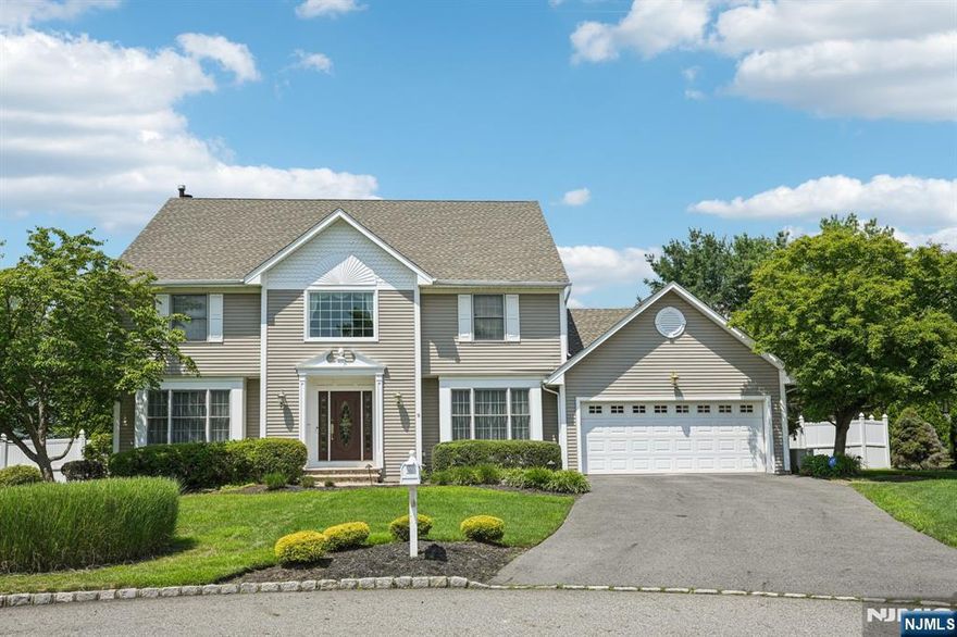 Welcome home to this beautifully maintained 4-bedroom, 2.2-bathroom Colonial nestled on a manicured lot in a quiet, sought-after neighborhood. A stunning two-story entry foyer welcomes you into the light-filled main level. The elegant living room flows seamlessly into the family room, where a wood burning fireplace creates a warm and inviting atmosphere. Sliding glass doors lead to a sun-drenched sunroom with expansive windows, offering views of the lush backyard. The updated kitchen is a chef's dream, featuring custom cabinetry, marble countertops, stainless steel appliances, a center island with bar seating, and a sunny breakfast nook. A formal dining room, powder room, pantry, laundry room, and garage entry complete the first floor. Upstairs, the luxurious primary suite boasts a sitting area, walk-in closet, and spa-like en suite. Three additional spacious bedrooms and a full hall bath provide room for everyone. Finished basement offers flexible space for a home office, gym, or rec room, along with a dedicated storage area. Step outside to your own private retreat with an expansive patio and in-ground pool surrounded by mature landscaping creating the perfect setting for outdoor entertaining or peaceful relaxation. With a two-car attached garage and ample driveway parking, this exceptional home offers both comfort and elegance, blending everyday functionality with resort-style living. Live the lifestyle you've dreamed of in this private, beautifully appointed retreat.