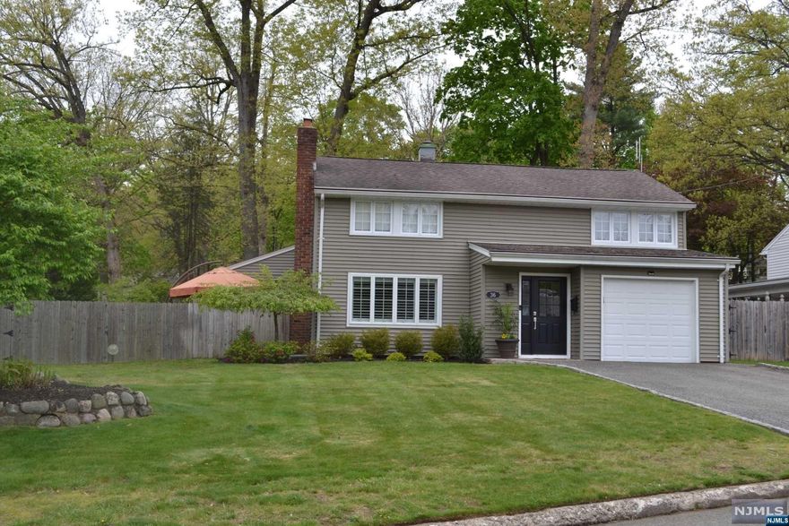 Immaculate, move-in condition with a 4th bedroom or office (tandem) 2 1/2 bath Zamore Colonial home on Ridgewood border. The first-floor features entry foyer, living room with fireplace, dining room with Pella sliding glass doors lead to brand new patio, updated kitchen with granite countertops and high-end stainless-steel appliances, Family room leads to a large deck, large flat fenced-in yard with room for a pool. 1/2 bath, 2 pantries, access to garage. The second floor offers large bedrooms. The primary bedroom with new full bath and 2 closets, one is a Walk-in. Upgraded electric with 200 amp, central air, new reverse osmosis water filtration and new whole house water softener, connection for a whole house generator, level 2 EV charger outlet, custom blinds, custom molding, custom closet organizers throughout. Blue Ribbon elementary school and ideal location down the street from Habernackel park and transportation. Blue Ribbon schools. Owner has NJ real estate license