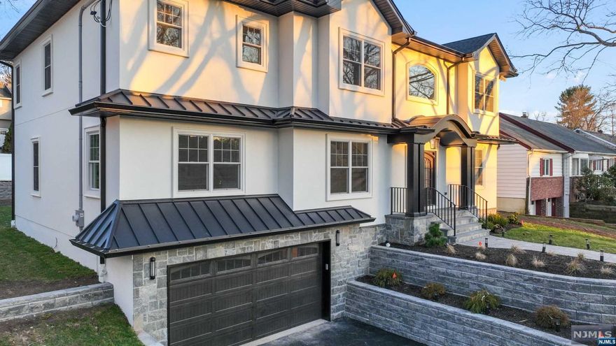 A MUST-SEE IN PARAMUS! This stately hilltop new construction 5 bedroom, 7 bath home is the perfect choice for anyone looking to live minutes from major shopping and transportation. The large living room and formal dining room are an entertainer's dream, with an adjacent butler pantry. The gourmet kitchen features a premium Thermador appliance package, a large center island, and a wet bar with a beverage center, opening to a large family room with a patio door with rear access. The 1st floor also features a large extra bedroom suite. On the second floor, enjoy the primary suite with Fireplace, a dual walk-in closet and a luxurious bath with a soaking tub. Full-height finished basement with rec room and Movie Theater. A stucco exterior, energy-efficient Andersen windows, three zones of central air, and custom carpentry throughout.