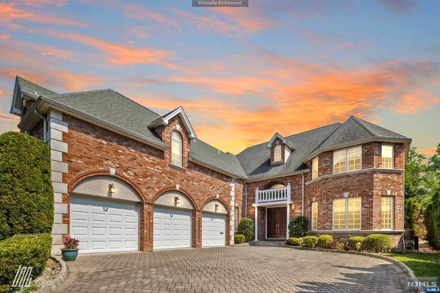 (info@1080arcadianway.com) Tucked away in the Bluff section of Fort Lee, this 6BR/5.1BA, 5,000+sqft residence brilliantly captivates with a stately red brick exterior, immaculate landscaping, and a custom paver driveway. Fashioned for modern entertaining needs, the interior boasts soaring foyer ceilings, soft natural light, crown molding, spacious living room w/fireplace, elegant formal dining room, and a gourmet kitchen with Viking appliances and granite countertops. Step outdoors to find a custom patio, blissful water feature, and ample greenspace. Fashioned for luxurious comfort, the upper-level primary bedroom includes a private balcony, cozy fireplace, abundant closet space, and an en suite with steam room and jetted tub. Other features: heated 3-car garage, large laundry room, 2nd floor NYC and Hudson River views, near shops, restaurants, parks, George Washington Bridge, and schools, and much more!