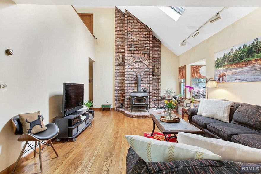 Set on a quiet cul-de-sac of beautiful homes, this lovely 3/4 bedroom, 2 bath Ranch boasts soaring ceilings, an incredible layout & a wonderful picturesque property. The immense front yard adorned w/2 gorgeous dogwood trees provides for incredible curb appeal & a park like environment, w/the beautiful front porch overlooking the serene setting. The vaulted ceiling 2 Story Great Room features dual skylights, a bay window & a soaring floor to ceiling wood-burning stove, the true centerpiece of this home. The adjacent Dining Room with fireplace has views of the front yard. The large Eat-In Kitchen opens to a spacious Breakfast Room which leads out to the lovely deck & rear patio. The Primary suite has 2 double closets, custom built-ins & a Primary Bath. There are 2 additional bedrms & a large full bth. Upstairs you find a large home office/4th Bedrm & an incredible loft w/2 more skylights overlooking the wonderful soaring ceiling 2 story Great Room.Top Rated Schools, EZ NYC Commute!