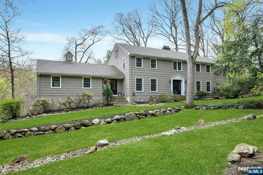 Charming and sophisticated custom colonial set on 1.36 acres of parklike property with your own natural waterfall/pond surrounded by lush mature specimen trees and shrubery. Your very own piece of natural serenity; situated behind the private gates of the Smoke Rise active community. Country living yet near NYC, premiere shopping/restaurants. Enjoy top rated schools Kinnelon has to offer as well as close proximity to askiing and the Jersey Shoree! Three levels of elegant living space to include many rooms offering picturesque views of the pond and gorgeous natural setting this lot offers. This home offers both spacious living space for the largest of gatherings and cozy intimate settings for those special occasions. Timeless elegance exudes with the goreous hardwood flooring, built-in cabintry and special touches throughtout all 3 levels.