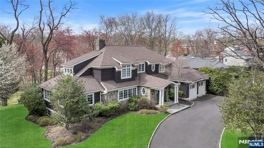 Set on a quiet, tree-lined street in the sought-after Glenwood section of Short Hillsâ€”just a half mile from the train, Glenwood Elementary & the Cora Hartshorn Arboretumâ€”this elegant 5,000+ sq. ft. home blends location, luxury & lifestyle. Custom built in 2002 by Simonian Rosenbaum Architects, it offers sunlit sophistication across 3 levels. The gourmet kitchen features Viking, KitchenAid & GE appliances, an oversized island & sunny breakfast area opening to a spacious deck. Enjoy the cozy den or host in the formal dining & lounge areas. The bright family room boasts a custom wood-burning fireplace. A 1st-floor bedroom or private office with full bath access & entry from the 2-car garage adds flexibility. Upstairs: a luxurious primary suite with cathedral ceilings, dual walk-ins, dressing area & spa bath. Three more bedrooms & a full hall bath complete the level. The walk-out lower level includes 2 rec rooms, gym, 6th bedroom, full bath & laundry perfect for guests or multigen living.