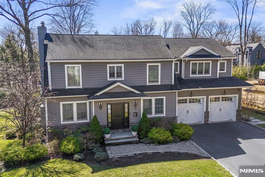 Stunning Center Hall Colonial seamlessly blends classic charm with modern luxury. Fully renovated in 2014, this home sits on a 12,500 sq.ft. lot & offers 4BR/3.5BA. The 1st Fl boasts an entry foyer, hardwood floors, FDR w/ wainscoting and crown molding, and an EIK w/ Quartzite island, custom cabinetry, 6 burner stove, double wall oven, microwave drawer, and French doors to the patio. The den fts built ins, buffet, and a Quartzite counter, while the FR offers a gas FPL, built ins, and window seating. Mudroom w/ built ins connects to a spacious two car garage. Upstairs, the luxurious primary suite ft custom WIC, marble bath w/ a soaking tub, glass shower, and private office. A junior ensuite and two additional bedrooms share a hall bath. The finished third floor offers a playroom/office, and the lower level includes a rec room and gym. The backyard features a dual level stone patio, converted garage, fire pit, and more. Close to top-rated Tenafly schools, downtown, and NYC.