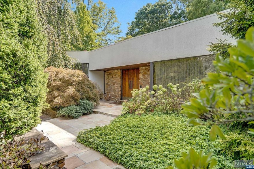 Iconic contemporary modern house over 5300 sq feet, set on 1.57 acres of meticulously landscaped, serene ground is a true home in prime Alpine. This impeccably renovated house brings in natural sunlight through floor to ceiling walls of glass and exposes the spaces to the panoramic views in every room. The spectacular Great Room has a soaring ceiling of almost 20 feet, wood burning fireplace and sliding glass doors leading to a private garden oasis. With an optimal layout, this home features an ideal split-bedroom layout for the utmost privacy. The home includes a gourmet chef's eat-in kitchen, large center island, top-of-the-line appliances, and formal dining area that opens onto the extensive rear yard. This move-in ready modern architectural masterpieces house is now available to the buyer who wants the quintessential lifestyle estate.