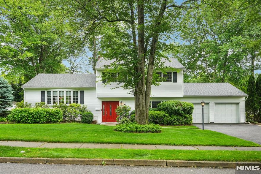 Welcome to this beautifully maintained 3BR, 2.5BA Split Level home, ideally located on a manicured lot in a commuter-friendly area. The ground-level entry opens to a spacious family room with large windows, custom built-ins, and a cozy wood-burning fireplace. A powder room, laundry, and garage access add convenience. Upstairs, enjoy a sunlit living room that flows into an elegant dining room with sliders to a large deckâ€”perfect for entertaining. The eat-in kitchen features custom cabinetry, granite counters, and stainless steel appliances. The upper level includes a generous primary suite with private bath, plus two additional bedrooms and a full bath. A finished basement offers flexible space for a gym, office, or rec room. Outside, enjoy a private fenced yard with wooded backdrop, spacious deck, and in-ground poolâ€”ideal for summer fun. Whole-house Kohler generator included. Close to NYC transit, shopping, and diningâ€”this home offers comfort, style, and convenience.