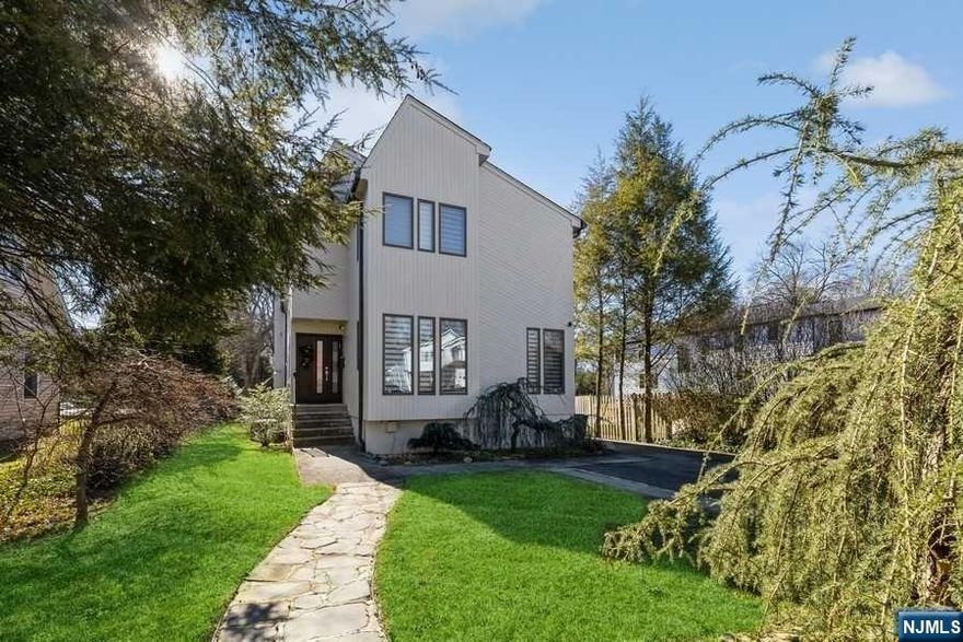 Welcome home! Coveted Tenafly location close to parks, schools, NYC transportation and more. Boasting renovations and great natural light thanks to plenty of skylights that beam off updated hardwood floors. Enjoy spacious living room, handsome dining area, renovated kitchen with updated tiles, countertops, appliances and fireplace, making entertaining fabulous! Second floor boasts a primary bedroom with Jacuzzi and full bathroom plus lovely additional bedrooms and renovated bathrooms. Finished basement equipped with office, full bathroom, washer and dryer, and plenty of room for storage. From security system, beautiful landscaping, garage renovation, and more, this residence has been fully updated making this home a move-in-ready dream. A true gem and an absolute must see!