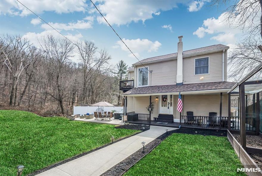 Spend time unwinding on your beautiful patio, surrounded by nature and peaceful scenery, complete with hot tub. An adorable wraparound front porch warmly welcomes you into this charming alternative to townhouse living. Inside, you'll love the open floor plan featuring a seamless Living and Dining room combination, a functional galley kitchen, and a convenient powder room with laundry on the main level. Upstairs offers two spacious bedrooms and an updated full bath, with the primary bedroom boasting its own private balcony perfect for morning coffee or evening relaxation. A standout feature, not to be missed, is the bonus detached air conditioned cottage, ideal for a home office, art studio, guest suite or whatever your imagination desires, complete with its own full bath, laundry and kitchenette. Additional highlights include recessed lighting, beautiful wood floors, ample basement storage, and major updates such as septic system 2022, roof 2025, updated electric, windows, split A/C units, and EV charger. Don't miss this unique opportunity. Conveniently located near Route 287, with easy access to restaurants, shopping, hiking, boating, and more. Close to NYC transit & Express NYC bus.