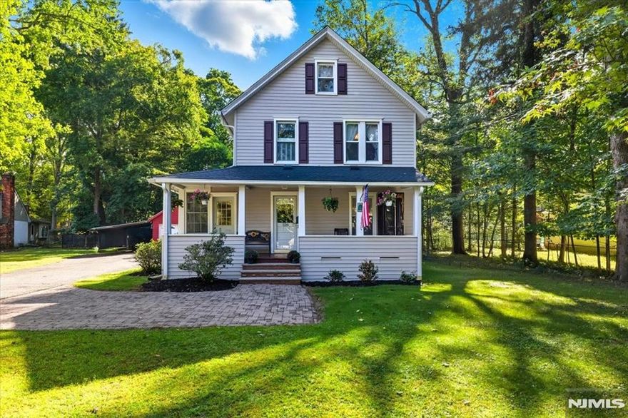 1920s Colonial on over three-quarters of an acre of fenced-in grounds. As you approach the property, you are immediately greeted by the timeless beauty of a fieldstone wall framing the front yard, a classic detail that sets the tone for this home. Mature trees and carefully maintained shrubs surround the property, giving the yard a sense of privacy and tranquility that is rare to find so close to Downtown. The open front porch invites you to sit back, relax, and enjoy the setting! The enormous great room is one of the standout features of this property light filled, versatile and provides endless possibilities for entertaining, recreation or creating the ultimate family gathering space. The primary bedroom offers an exceptional level of privacy and comfort. Step onto your private veranda overlooking the fenced-in yard and unwind with your morning coffee. Inside is a large walk-in closet and a luxurious primary bath. This home is not just another listing; itâ€™s an opportunity to own a piece of Ramseyâ€™s past and present, all while securing a future filled with comfort, convenience, and possibility.