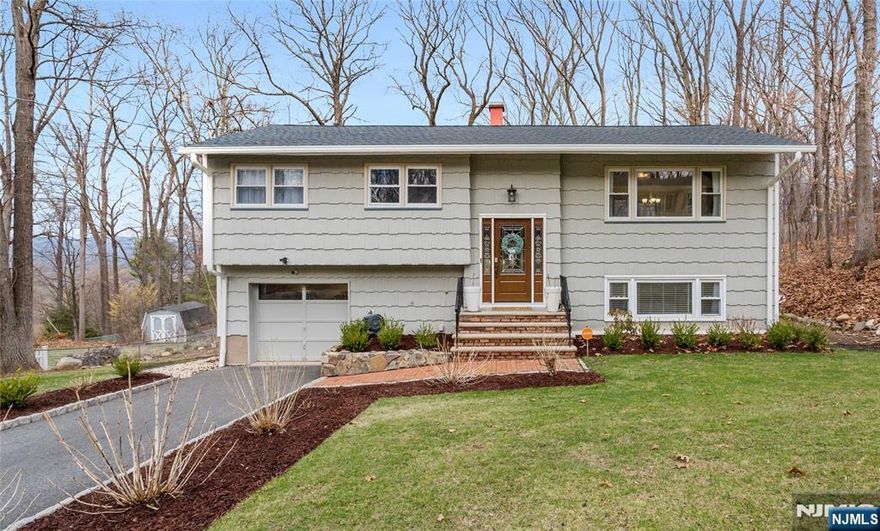 Beautifully updated home in a tranquil and convenient location close to major highways, shopping, entertainment, and more, this home shows pride of ownership and it has been meticulously maintained for its next occupants delight and peace of mind, homes consists of open living and dining room with a sliding doors that gives way to a 2-level deck and expansive yard, elegant kitchen with stainless steel appliances, modern cabinetry, island and countertops, living room with decorative chimney and prestine hardwood floors, 3 bedrooms, full renovated tiled bath (and master with half bath), the ground level features a spacious bedroom, living/family room with bar and slider to yard, full tiled bath, laundry room and plenty of closets, area suitable for a small office space if desired and garage, home features modern tech including a remote controlled sprinkler system, newer whole house filtration system, new roof recently installed and much more, DON'T MISS THIS ONE!