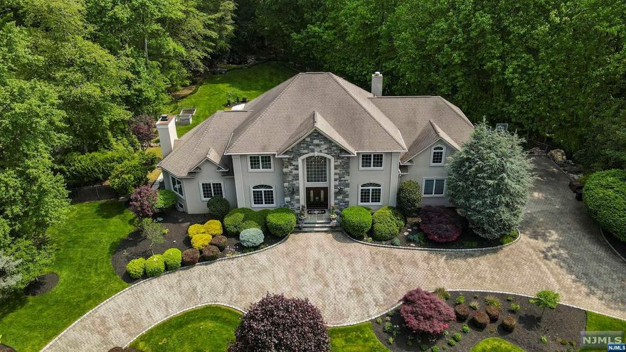 Stunning custom built colonial home nestled in the Water's Edge area of Old Tappan that boasts timeless elegance & modern updates. Offering 5 spacious bedrooms & 3.5 baths. Freshly painted interior that exudes a sense of warmth. The first level boasts a beautiful EF, FLR, & opens up to the updated MEIK that is a culinary dream ft. a large island, high-end appliances, & abundant storage space. A BDR/home office, FBTH, and mudroom complete the first floor. On the second level is the large primary BDRM & bath ft. custom built in closets & relaxing jacuzzi tub, 2 additional BDRMS, spacious den/loft room, FBTH, & large LDRY RM. The full, finished basement offers a wet bar, additional kitchen, & a versatile rec room/movie theater. The outdoor space is a true oasis, complete w/ outdoor kitchen & sink, outdoor in-ground heated pool, new Italian Porcelain patio, granite fire table top, & a serene backyard waterfall- all perfect for entertaining. Whole house generator. Original owners.