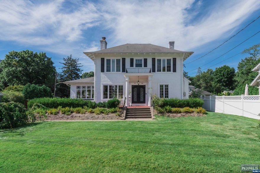 The high ceilings and countless windows found throughout this stunning Colonial are reminiscent of the charm and character of the past while the modern updates & custom accents of this home reflect a bright and sophisticated style. A huge island in the renovated Kitchen is the perfect gathering place, opening to the spacious formal DR. Picture yourself reading or practicing yoga in the sunroom with its original stained glass windows! The large adjoining LR features a wood burning fireplace with a gorgeous mantle, and the office (or den?) boasts an original built-in that will wow any guest! Upstairs, the primary bedroom suite features a built-in reclaimed wood desk and renovated bath with large walk-in shower and closet, while a large main bath and 3 more bedrooms round out the 2nd level. Situated on a corner lot with a generously sized yard, close to downtown GR & train line, this home is truly special inside and out!