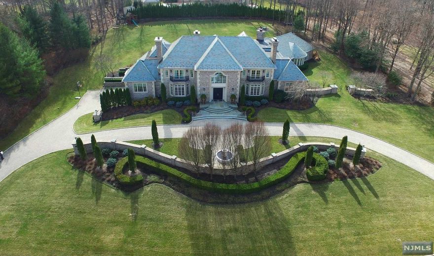 Luxury Built Brick Estate Home with a Slate Roof & Set on 2 Acres. Hand carved mahogany doors. 2-story marble foyer with dual bridal staircase. Warm & inviting living room & elegant dining room, both with fireplaces. Magnificent great room, fireplace & built-in cabinetry & wall of windows overlooking the grounds. Uniquely designed bar room with a wet bar with access to patio and perfect for indoor & outdoor entertaining. Office on the 1st floor with fireplace. Upscale kitchen with top-of-the-line appliances is one-of-a-kind & perfect for a chef. Adjoining the kitchen is a very light & bright breakfast room with fireplace. In a separate wing there is a spectacular indoor pool & spa with fireplace for year round entertaining & has multiple French doors opening to the patio. Beautifully appointed primary suite with fireplace, private staircase, custom closets & lavish bath. Lower level has media room, family rm, gym & bath. 5 car garage. Rio Vista amenities:pool/tennis/gym/clubhouse.