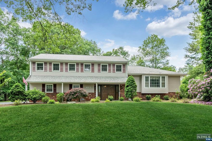 Beautiful location, spacious floorplan, and a large yard - it's all here for you! This expanded home boasts approximately 3,000sf of living space and offers a variety of upgrades, including newer roof, driveway, skylights, Trex deck, 20kw gas generator, 200amp electrical service, security system, hot water heater, AC compressor, and garage doors. Enjoy gatherings in the 17x25 family room with fireplace, which is open to the kitchen, while still having a formal living room and a lower-level recreation room. The kitchen has its own breakfast area, as well as 5-burner stovetop, double oven, SubZero refrigerator, stone counters, and center island. Other amenities include a primary bedroom suite, laundry room, attached two-car garage, and multiple zone HVAC. The spacious yard includes wooded privacy, and a large deck with gas line for the grill. Municipal water and sewer. Pride in ownership is so apparent in this wonderful home - come make it yours!