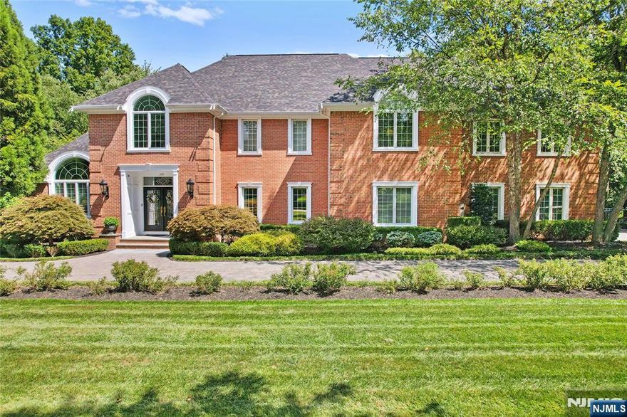 Elegantly appointed brick and cedar colonial manor beautifully updated on sought after street with great supporting value. 2 story entrance hall and great room with fireplace & built-ins. Detailed woodworking throughout, coffered ceilings and wainscoting. Large updated kitchen with Quartz countertops, French doors leading to large stone veranda which overlooks the beautiful Marson heated inground saltwater pool and spa surrounded with paver deck. Property is lushly landscaped with many specimen plantings. Rear corner of lot has wetlands buffer offering very private setting overlooking picturesque pond. 3 car attached garage and natural gas generator. Full list of upgrades available. Owner has NJ Real Estate License.