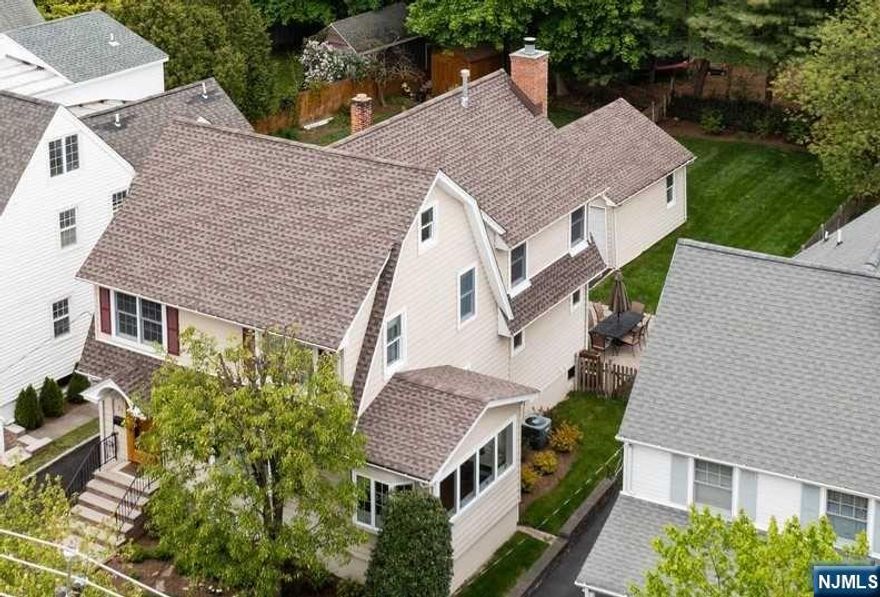 Meticulously updated and expanded 4 / 5 Bedroom, 2 Full and 1 Half Bathroom Colonial located in one of the best neighborhoods a few blocks from South Mountain Elementary School, Taylor Park and downtown Millburn + less than a half mile to the Millburn's NYC Direct Train Station. Modern upgrades are everywhere including a magnificent Kitchen / Family Room / Primary Suite addition. Gourmet Chef's Kitchen features granite counters, high-end appliances and breakfast bar. Living Room flows to Sunroom and formal Dining Room. Family Room with a floor-to-ceiling brick wood burning fireplace. Updated Powder Room completes 1st level. Primary Bedroom Suite provides 2 walk-in closets, hardwood floors and luxe Bathroom. 2 additional bedrooms on this level + office with closet + updated Full Bath rounds out 2nd level. Private 3rd floor Bedroom runs width of house. Lower Level has Gym, Laundry + space for Rec Area. Backyard is fully fenced with a gorgeous paver patio and Kitchen access.