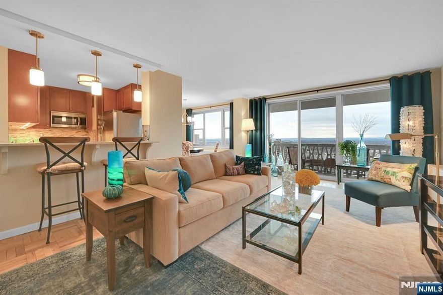 Beautifully appointed, this west facing, high floor large one bedroom is ready for you to move in! From the entry, you can tell the seller lovingly renovated the kitchen to incorporate it into the living room and dining areas for a wonderful entertaining area. The terrace off of the living room offers a birds eye view of serene and majestic sunsets. The bathroom has been updated and the bedroom offers a large walk in closet. A HUGE walk in closet in the hallway can offer much need storage or converted into a home office...whatever your lifestyle commands. Additional hall closets for coats and household items. Med South offers 24/7 concierge/security service, on site management and maintenance offices, community room, gym ($15/month per resident), athletic courts, pool and playground. Choice of Spectrum or Verizon FiOS for cable/internet. Parking assigned after closing, depending on availability $95/$85/$75 per month per car. Close to NYC bound buses and major NJ highways. Near to Fort Lee's eclectic restaurant scene. Free Columbia shuttle across the street for their employees. Truly a wonderful building to call your next new home.