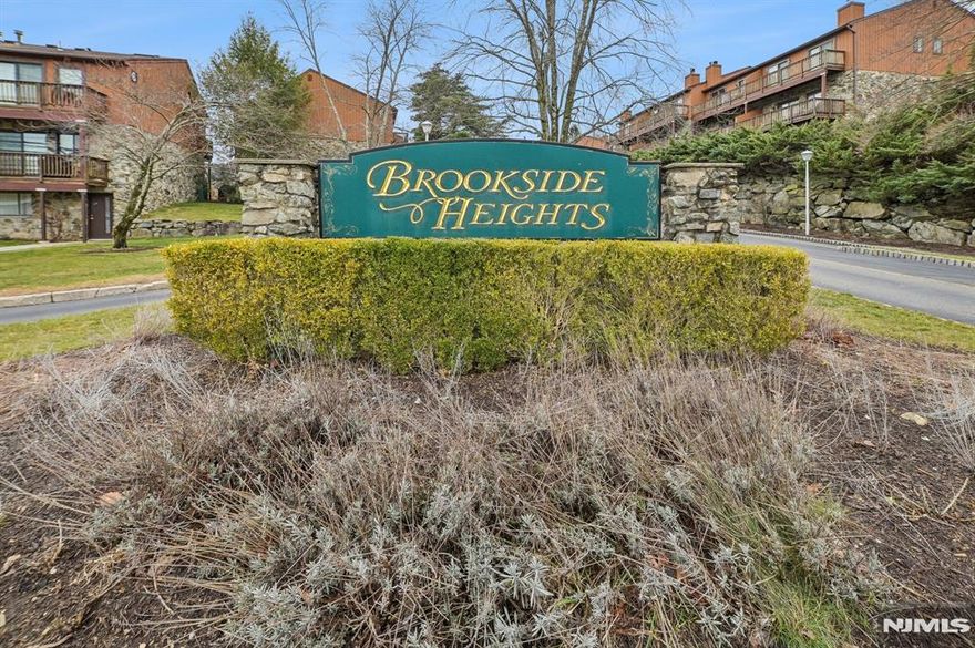 Brookside Heights 2 bedroom interior unit multi-level townhome. This unit boasts an updated kitchen, Powder room, Formal Dining Room & Living Room with wood-burning Fireplace & slider to good sized deck w gas grill (INCLUDED). 2nd floor offering 2 bedrooms, newer laminate flooring. Primary bedroom with Deck, double closets, jetted tub, Bathroom with double sink and shower . Plus large linen closet. Main Bath has tub/shower with additional Linen Closet. 2nd bedroom offering additional deck, double closets. Basement has large Family room, part tile & Part carpeted with slider to outdoors. Laundry/Utility room with some storage cabinets, washer/Dryer. This home is being sold in as is condition, inspections for informational purposes only. 2 assigned parking spaces come with the unit Labeled 1F. Close proximity to Lakeland High School.