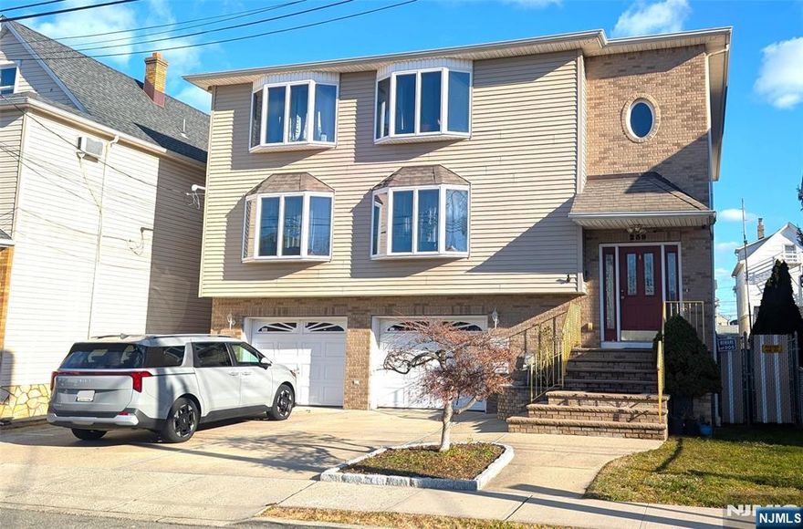 Huge, Nearly 3500 square foot three-level custom built multi family property! 6-7 bedrooms and 4.5 full baths spread over 3 floors! The 1st floor combines with the ground floor to offer 3 bedrooms (primary bedroom with primary bath), huge formal living room, kitchen, dining area, 2 full baths, tons of closets PLUS a large family / recreation room, wet bar, storage room, half bath and laundry room on the lower level. The 2nd floor offers a massive living room, eat in kitchen, dining area, 3 large bedrooms ( primary bedroom with primary bath), 2 full baths, tons of storage and separate laundry area hookups on ground floor. Separate gas, electric, heat and hotwater. 2 Newer central air units, ground level split unit plus multi-zone hot water baseboard heat in each unit. Attached 2 car garage, wide driveway, spacious back yard with paver patio, and large shed with 100 amp electric service. Closet to parks, Schools, Shopping and NYC transportation within walking distance. Property Taxes for 2025 were $18,067 Zillow shows incorrect information.