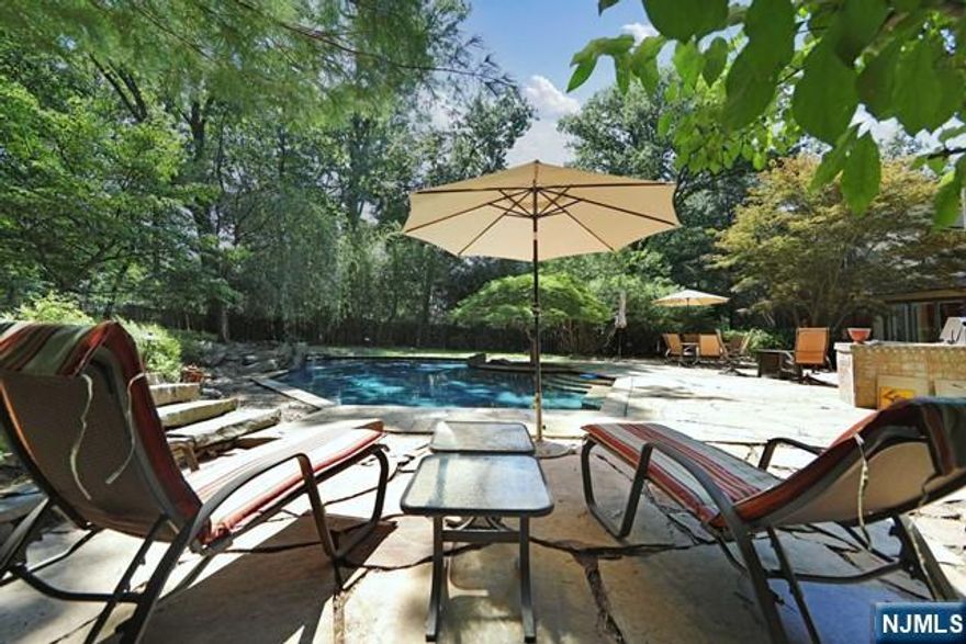 Stunning Englewood Contemporary with Breathtaking Views! Perched high on the hill, this 4-bedroom, 4-bath home offers sweeping western views and a beautifully renovated open floor plan. The backyard is a private oasis with a heated gunite pool, outdoor kitchen with BBQ, play area, and wooded surroundings. Inside, natural light fills every room. The living, dining, and family areas flow seamlessly, anchored by a gas fireplace. The chefâ€™s kitchen features granite countertops, Wolf appliances, and direct access to the backyard. The primary suite includes a fireplace, spa-like bath, two walk-in closets, and a private deck. A separate wing currently serves as an office but is ideal for a guest suite. Just 6 miles from NYC, near shopping, dining, and houses of worshipâ€”this home is perfect for entertaining and everyday living!