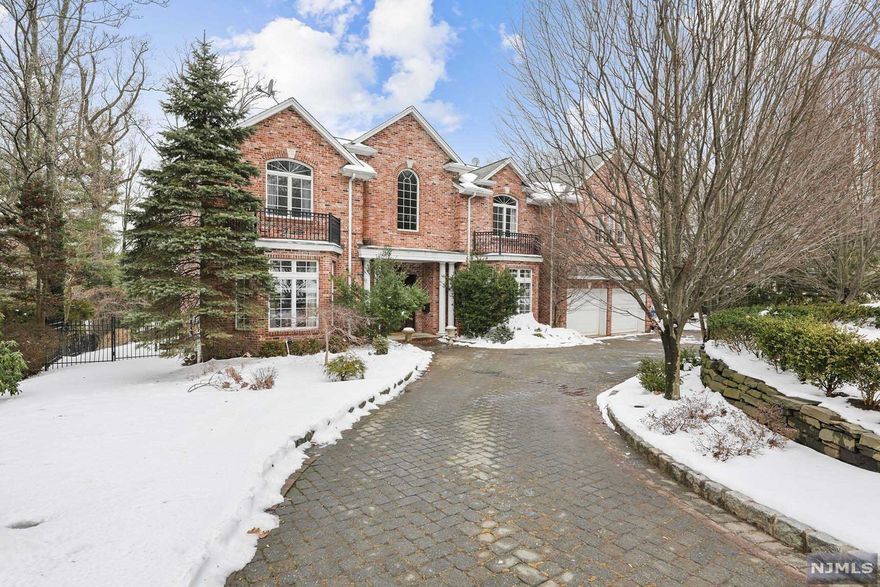 LOCATION, LOCATION, LOCATION! Brick Center Hall Colonial set on a 1/2 acre property located on a cul-de-sac high on the East Hill of Tenafly. The deep rear yard has a large patio for entertaining and room for a pool. The home was built in 2001 and boasts large bright rooms with 9 and 10 foot ceilings, oversized windows, custom moldings and hardwood floors throughout. The main level consists of a two story entrance, living room, dining room, gourmet kitchen open to a large family room with fireplace, library and guest powder room. The second floor boasts a well appointed Primary Bedroom Suite, 2 additional bedroom suites, and two bedrooms with a connecting bathroom. The basement is fully finished with recreation rooms, bedroom, bathroom and wine cellar. Excellent schools, close to NYC, shopping and major highways. Won't Last!