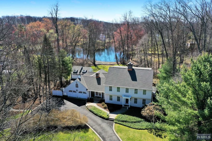 Shadow Lake! Captivating, distinctive custom colonial in impeccable condition! Stunning lakefront property is beautifully landscaped and showcases a sweeping yard, rear patio, pergola, and additional stone front carriage house! Main floor offers a welcoming foyer, spacious living room with fireplace, and formal dining room with French doors to a lovely rear patio. The gourmet kitchen opens to a large breakfast room with fireplace, that flows into a vaulted ceiling family room with walls of windows accenting the light and emphasizing the dazzling water views. Convenient 1st-floor office plus full bath off foyer. 2nd-floor primary suite features a stunning updated spa bath and large walk-in closet, plus 2 additional bedrooms and updated full bath. 3rd level boasts an additional bonus room or bedroom approximately 35x13 plus another 14x10 space with many possibilities for this huge space. Carriage house and attached garage parks 4 cars. Fish and kayak from your own yard! Generator!