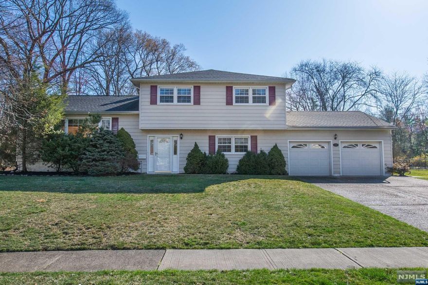 Incredible location, beautiful large property & desirable layout. Home Features: 4 bedroom & 2.5 bathrooms. Inviting foyer leading to expansive family room with fireplace; great for entertaining! Tradition formal living room and dining room, first floor bedroom offers walk - in closet and exterior access. Great opportunity for office or in-law suite. Sun filled eat in kitchen and convenient laundry room. Second level features: 3 nice size bedrooms including primary suite with ample closets and full bathroom. Hardwood flooring throughout (under carpet), tons of natural light, and sliding doors off of the dining room leads to maintenance free deck. Oversized two car garage and basement for storage. Impressive large level property for all your outdoor enjoyment. Desirable location of Black Oak Estates: sought after neighborhood. Top rated schools. Minutes to shopping, recreational activities, major highways, restaurants, Whole Foods, Trader Joe's & NJ Transit bus/train station.