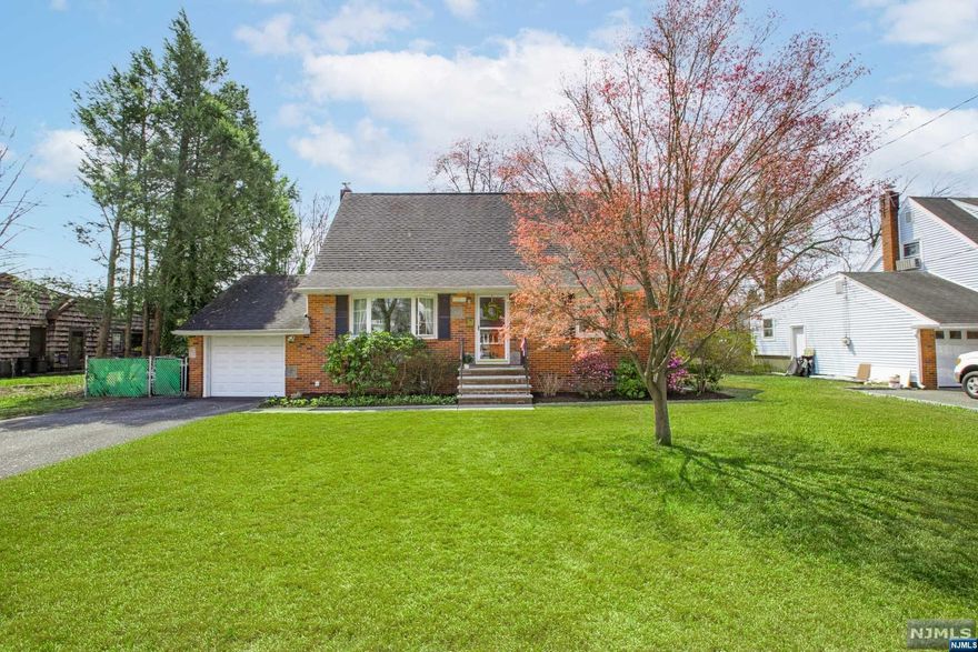 TOO GOOD TO MISS!! Envision yourself in this appealing classic brick-front cape cod. Sun-drenched rooms; hardwood floors on 1st floor (living room, dining, 2 bedrooms); wood floors on 2nd level. Spacious primary bedroom on 1st floor, along with child's bedroom/office/den. Both bedrooms on 2nd floor are quite large with multiple closets and storage. Half-bath on 2nd floor can be expanded to full bath. Younger thermal windows, central A/C on both floors; 200-amp wiring, 50-gallon water heater, attached garage with opener. A portion of the basement is semi-finished. Laundry area has double utility sink. Level property with deep,fenced rear yard; storage shed. 5G Fios enabled. Stroll to abundant shopping, services and NY transportation. Sellers seek June 30 closing date. ***BEST & FINAL BY 10 AM TUESDAY, 4/18***