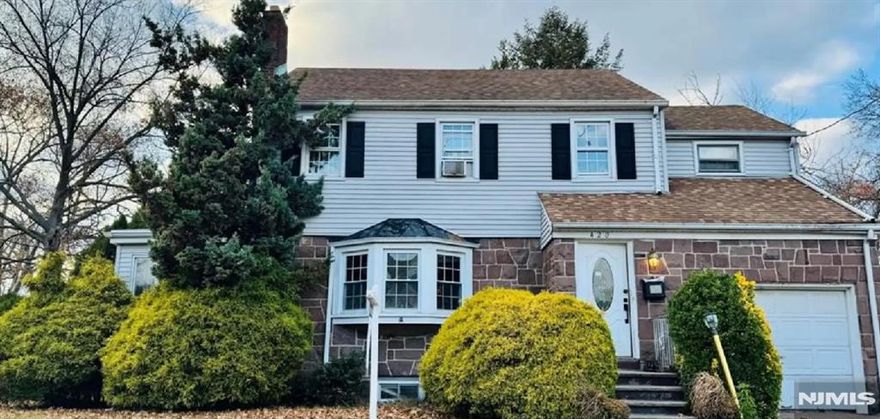 Located in a quiet and tranquil part of Paterson, close to East Side Park Historic District. This charming property sits on a spacious corner lot and offers a flexible layout ideal for a potential mother/daughter setup. It features 4 bedrooms, with 1 conveniently located on the first floor and 3 upstairs. Enjoy its spacious living room with a cozy fireplace, formal dining room, and an updated eat-in kitchen with newer stainless-steel appliances. The fully finished basement includes a private entrance, providing additional space. A stand-up attic offers the opportunity for future finishing, while the attached garage adds convenience and storage. Enjoy outdoor space on both sides of the property, taking full advantage of the desirable corner lot setting. The home is located on the corner and displays the number 420 East 19th Street on the exterior. Call Me to schedule a private showing at 201-774-4420.