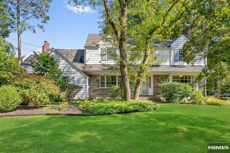 Nestled in Englewood's Manor Section, this Classic Center Hall Colonial is offering generous living space with timeless charm. Perched on a picturesque knoll overlooking a sparkling brook, this beautifully maintained home features 11 rooms, including Primary Suite with new FBTH, 3 additional spacious bedrooms and 2 additional full bathrooms. 2 Zones Central Air Conditioning and 10 Zones Sprinkler's System. With its ideal blend of suburban tranquility and proximity to New York City, this residence offers the best of both worlds. Inside, you'll find a well-balanced layout perfect for everyday living and entertaining, along with abundant storage throughout. Don't miss the opportunity to own a piece of classic elegance in the Manor neighborhood!