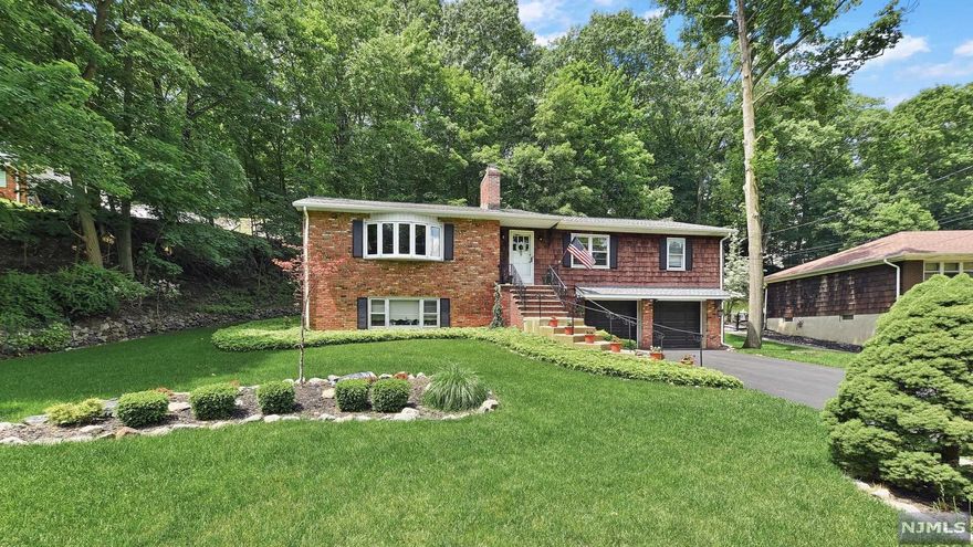 This impeccable raised ranch shows true pride of ownership! Approx. 3,000 sq ft of living space! Looking for in-law suite or extended family arrangement? This one is "IT" Entry foyer welcomes you into an oversized light, bright living room w/fireplace, dining area, and large eat in kitchen w/ss appliances! Hardwood under carpeting as installed, master bedroom w/master bath, two addtl. BRs and a full bath complete the first level. Ground floor has entr to gar., and in-law suite w/BR, Full BA, FR, KIT! Sewing room, storage, laundry and utilities complete the ground floor. Rear yard is a private oasis beautifully landscaped w/new patio and fenced yard. Whole house generator hookup! Roof 6yrs,AC 6yrs, Ht wt htr 2yrs! Great Pompton schools!