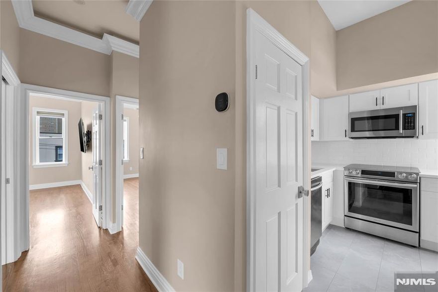 Welcome home! This beautifully renovated condominium is just what you've been looking for. With a cozy two-bedroom setup, it even boasts an extra room perfect for a home office or guest room. The brand new kitchen with quartz countertops and new ss appliances is sure to inspire culinary delights, and you'll love the convenience of having laundry right in your unit. The renovated bathroom has elegant Porcelanosa tiles and fixtures. Relax on your private rooftop or take advantage of your one-car garage with an EV charger. Plus, basement storage makes organization a breeze. And for added security and peace of mind, there's video intercom and door entry with remote access via smartphone. Situated by Boulevard East, you're close to stores, schools, and everything you need, with fantastic access to transportation to Manhattan.