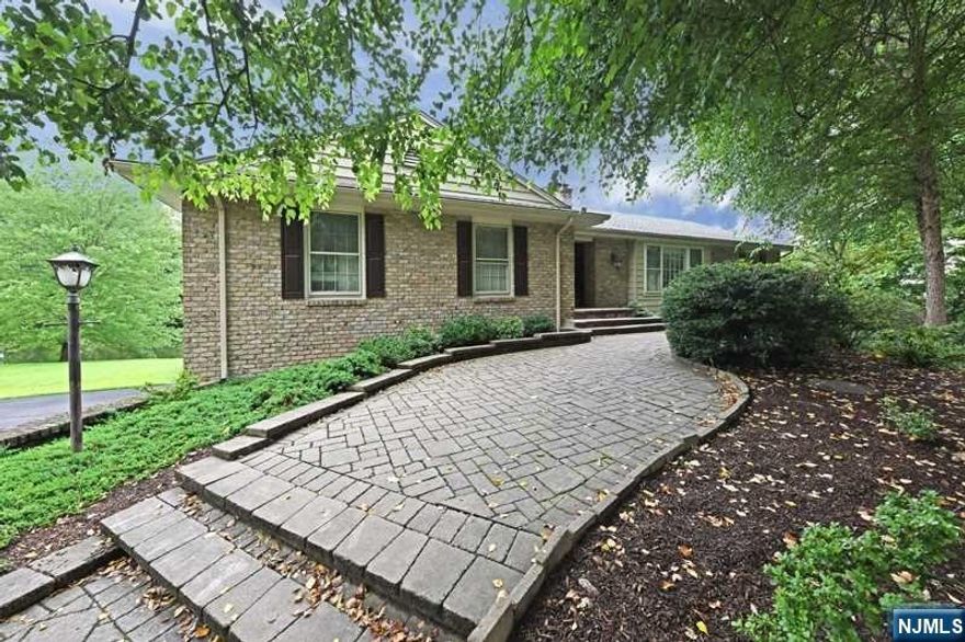 Welcome to this elegant, professionally landscaped Saddle River ranch. Soak in the SPECTACULAR views of the large pond from almost every room. The great room features a vaulted veiling, two sets of French doors leading t he composite deck and railings, picture window with transom and fireplace. The newer kitchen has s/s appliances,granite island, custom cabinets,built-in desk and sliders to deck. The primary bedrom with primary bath and custom closets,offers pond views through the wide sliders to the deck.Property is not in the flood plain(no flood insurance is necessary) The spacious, downstairs family room with sliders to patio has parquet flooring, a fireplace, full bath and is great for entertaining, or a home office/in-law suite. Enjoy the top-rated schools and low taxes.