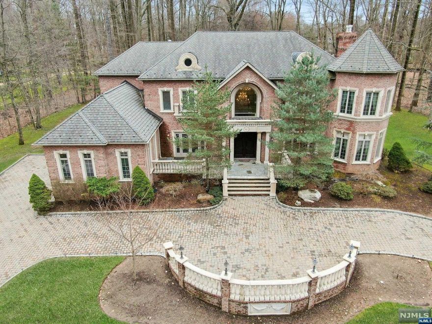 Majestic All Brick Colonial on 1+ acre of serene property with architectural details throughout.Breathtaking entry with beautiful winding staircase and marble floor.Expansive great room with soaring ceiling, fireplace and French doors to backyard. Large formal living room with fireplace. Gourmet kitchen with center island, granite countertops, high-end stainless appliances, radiant heat & spacious dining area. Banquet-sized formal dining room. Two large Junior suites with updated full baths, laundry rm and half bath completes 1st level.Second level, luxurious primary suite includes fireplace, dual walk-in closets and marble bath with jetted tub and shower. Two Junior suites with full baths and 2 spacious bedrooms w/ Jack-n-Jill bath. Expansive walk-out lower level offers kitchenette with granite countertops. Two bonus rooms, spacious living room w/ doors to patio. 3-car garage. Professionally landscaped property offers a paver driveway & serene two-tier backyard w/ paver patio.