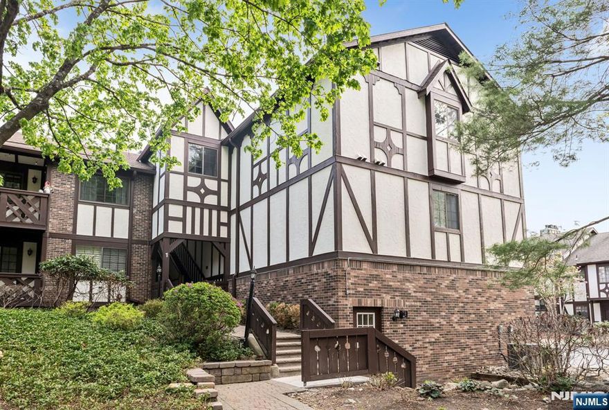 Bright and beautifully maintained, this spacious 2-plus bedroom, 2 full bath condo is set in the desirable Ridge Gardens community. Sunlight pours into the open living and dining areas, highlighted by newer flooring and a cozy gas fireplace with a modern stone surround. A private terrace offers a peaceful space to unwind and enjoy the tree-lined view. This model has an excellent layout with a versatile den, providing the flexibility for working from home, additional living space or even a 3rd bedroom. The primary suite features a custom walk-in closet and an updated en-suite bath. Both bedrooms have newer, neutral wall-to-wall carpet. A 2nd updated full bath completes the living space. A standout feature is the private one-car garage. Two ground-level storage bins offer ample extra space. Additional features include in-unit laundry with a new washer and dryer and new HVAC system (2024). With abundant natural light and thoughtful updates throughout, this home is move-in ready and not to be missed. Residents enjoy access to amenities including a pool, tennis, and pickleball courts. Ideally located just minutes from Ramapo Reservation, Campgaw skiing, and Darlington County Park for a great lifestyle!